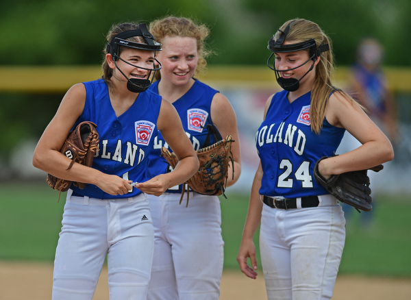BOARDMAN, OHIO - JULY 18, 2016: Starting pitcher Brooke Bobbey #1 of Poland smiles while clipping her finger nail while teammates Lauren Sienkiewicz #17 and Hannah Dinard #24 smile as they watch in the fourth inning of Monday afternoons Little League Championship game at Field of Dreams. Poland won 12-2. DAVID DERMER | THE VINDICATOR