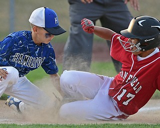 BOARDMAN, OHIO - JULY 19, 2016: Jake Grdic #17 of Canfield slides safely into third base beating the tag from Charlie Vidourek #2 of West Hamilton in the fifth inning of their game Tuesday night at the Fields of Dreams. Hamilton West won 2-0. DAVID DERMER | THE VINDICATOR