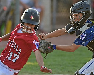 BOARDMAN, OHIO - JULY 19, 2016: Catcher Curtis Moak #6 of West Hamilton tags out Jake Grdic #17 of Canfield as he tries to score from third base in the fifth inning of their game Tuesday night at the Fields of Dreams. Hamilton West won 2-0. DAVID DERMER | THE VINDICATOR