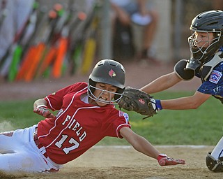 BOARDMAN, OHIO - JULY 19, 2016: Catcher Curtis Moak #6 of West Hamilton tags out Jake Grdic #17 of Canfield as he tries to score from third base in the fifth inning of their game Tuesday night at the Fields of Dreams. Hamilton West won 2-0. DAVID DERMER | THE VINDICATOR