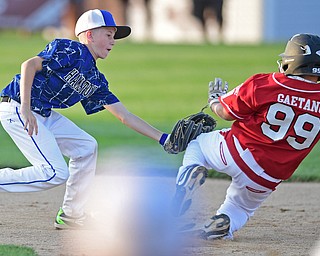 BOARDMAN, OHIO - JULY 19, 2016: Cayden Evans #1 of Hamilton West tags out Gianni Gaetano #99 of Canfield as he attempted to advance after a bad throw to first base in the sixth inning of their game Tuesday night at the Fields of Dreams. Hamilton West won 2-0. DAVID DERMER | THE VINDICATOR