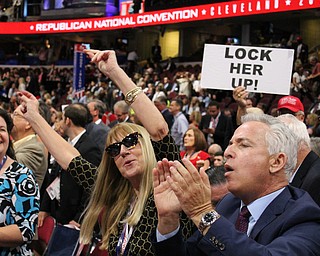 Other state delegates dancing on the floor, with a sign aimed at Hillary Clinton in the background..