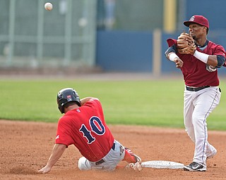 NILES, OHIO - JULY 21, 2016: Second baseman Erlin Cerda #4 of the Scrappers throws to first to attempt a double play after forcing out Andy Perez #10 of the Spinners in the second inning of their game Thursday night at Eastwood Field. DAVID DERMER | THE VINDICATOR