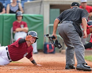 NILES, OHIO - JULY 21, 2016: Gavin Collins #44 of the Scrappers slides in the first after being tagged out at home plate by catcher Isaias Lucena #20 of the Spinners in the second inning of their game Thursday night at Eastwood Field. DAVID DERMER | THE VINDICATOR