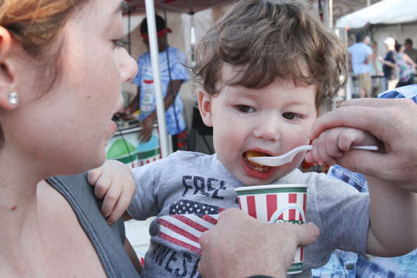 William d. Lewis The vindicator  Tucker Palmer, 17 months, gets a tasty treat from his mother Teal Palmer of Boardman during MtCarmel Festival in youngstown July 22, 2016.
