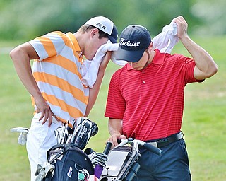 Jeff Lange | The Vindicator  FRI, JUL 22, 2016 - Cade Kreps of Boardman (left) uses Michael Melewski's towel to wipe his brow in between the second and third hole during the Greatest Golfer of the Valley Junior finals held at Avalon at Squaw Creek Friday afternoon.