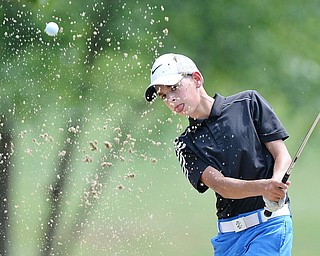 Jeff Lange | The Vindicator  FRI, JUL 22, 2016 - Dean Austalosh of Campbell blasts out of the No. 3 bunker during the Greatest Golfer of the Valley Junior finals held at Avalon at Squaw Creek on Friday.