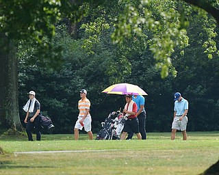 Jeff Lange | The Vindicator  FRI, JUL 22, 2016 - A group of golfers including Cade Kreps (in orange) and Anthony Graziano (right) walk down the No. 10 fairway in a drizzling rain during Friday's Greatest Golfer of the Valley Junior finals held at Squaw Creek.