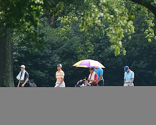 Jeff Lange | The Vindicator  FRI, JUL 22, 2016 - A group of golfers including Cade Kreps (in orange) and Anthony Graziano (right) walk down the No. 10 fairway in a drizzling rain during Friday's Greatest Golfer of the Valley Junior finals held at Squaw Creek.