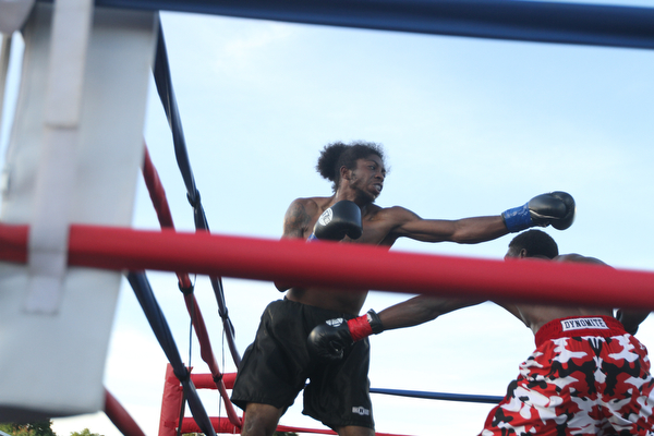 Nikos Frazier | The Vindicator..Fred Wilson of Cleveland(right) ducks as Rakin Johnson of Indianapolis, Ind.(left) swings in the second round of the first bout of the South Side Boxing Club Championship Night at the Covelli Center.