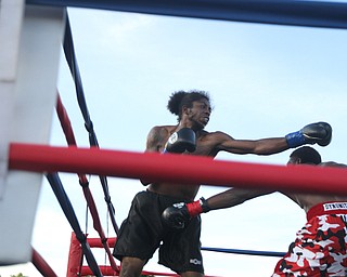 Nikos Frazier | The Vindicator..Fred Wilson of Cleveland(right) ducks as Rakin Johnson of Indianapolis, Ind.(left) swings in the second round of the first bout of the South Side Boxing Club Championship Night at the Covelli Center.