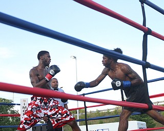Nikos Frazier | The Vindicator..Fred Wilson of Cleveland(left) backs up as Rakin Johnson of Indianapolis, Ind.(right) swings in the second round of the first bout of the South Side Boxing Club Championship Night at the Covelli Center.