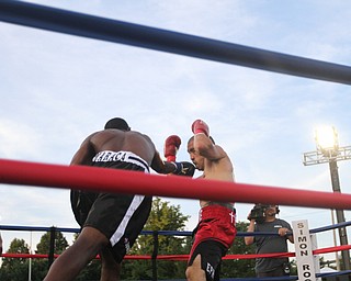 Nikos Frazier | The Vindicator..Jake "The Bull" Giuriceo(right) dodges a swing from Jose Abrue in the second round at the South Side Boxing Club Championship Night at the Covelli Center.