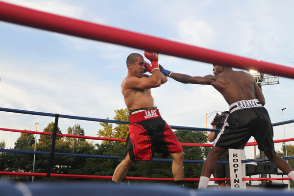 Nikos Frazier | The Vindicator..Jake "The Bull" Giuriceo(left) dodges a swing from Jose Abrue in the third round at the South Side Boxing Club Championship Night at the Covelli Center.