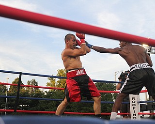 Nikos Frazier | The Vindicator..Jake "The Bull" Giuriceo(left) dodges a swing from Jose Abrue in the third round at the South Side Boxing Club Championship Night at the Covelli Center.