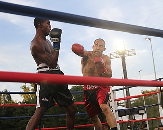 Nikos Frazier | The Vindicator..Jake "The Bull" Giuriceo(right) swings at Jose Abrue in the second round at the South Side Boxing Club Championship Night at the Covelli Center.