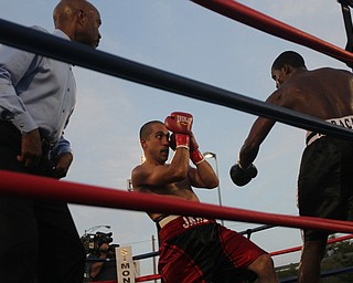 Nikos Frazier | The Vindicator..Jake "The Bull" Giuriceo(right) dodges a swing from Jose Abrue in the sixth round at the South Side Boxing Club Championship Night at the Covelli Center.