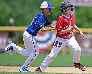 BOARDMAN, OHIO - JULY 24, 2016: Base runner Ryan Bennett #23 of Canfield is tagged out by Charlie Vidourek #2 of Hamilton after he was caught in a rundown in the third inning of Sunday afternoons Little League State Championship Game at the Fields of Dreams. Hamilton won 11-0. DAVID DERMER | THE VINDICATOR