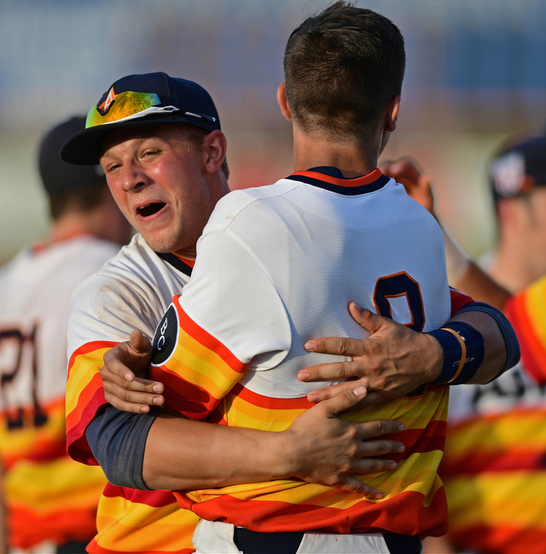 STRUTHERS, OHIO - JULY 24, 2016: Jared Kapturasky #8 is hugged by teammate Tyler Cannon #27 after the dramatic ending of the NABF Championship game Sunday night at Cene Park. Astro won 5-4. DAVID DERMER | THE VINDICATOR