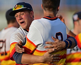 STRUTHERS, OHIO - JULY 24, 2016: Jared Kapturasky #8 is hugged by teammate Tyler Cannon #27 after the dramatic ending of the NABF Championship game Sunday night at Cene Park. Astro won 5-4. DAVID DERMER | THE VINDICATOR