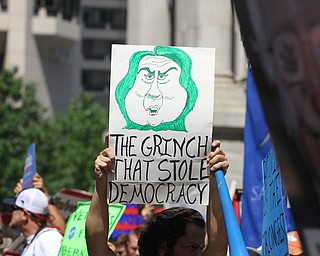 Nikos Frazier | The Vindicator..A protestor holds a "The grinch that stole democracy" sign by Philadelphia's City Hall on the first day of the Democratic National Convention.
