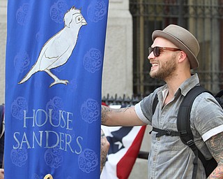 Nikos Frazier | The Vindicator..A protestor holds a "House Sanders" banner by Philadelphia's City Hall on the first day of the Democratic National Convention.
