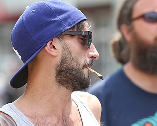 Nikos Frazier | The Vindicator..A protestor smokes a marijuana joint while walking with Sen. Bernie Sanders supporters on the first day of the Democratic National Convention in Philadelphia.