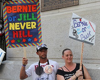 Nikos Frazier | The Vindicator..Two protestors hold signs in support of Sen. Bernie Sanders outside of Philadelphia's City Hall on the first day of the Democratic National Convention.