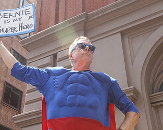 Nikos Frazier | The Vindicator..A Sen. Bernie Sanders supporter holds a "Bernie is my Superhero" sign while dressed as a superhero on the first day of the Democratic National Convention in Philadelphia.