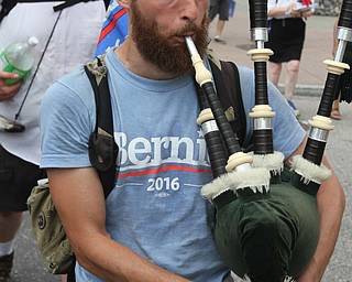 Nikos Frazier | The Vindicator..Jesse Bonelli marches with fellow Sen. Bernie Sanders supporters while playing the bagpipes on the first day of the Democratic National Convention in Philadelphia. Bonelli started teaching himself the Scottish instrument in 2010.