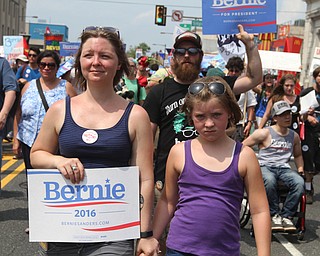 Nikos Frazier | The Vindicator..Julia Ensign(left) and her daughter, Amelia Robinette, 10, march with Sen. Bernie Sanders supporters on the first day of the Democratic National Convention in Philadelphia.