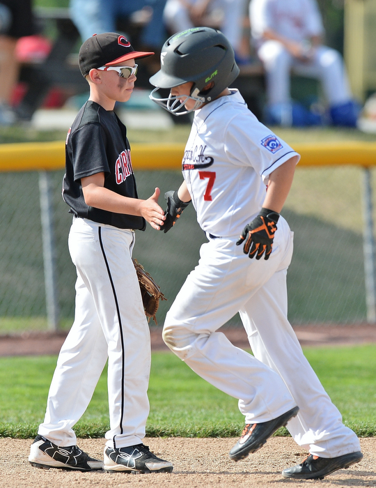 Jeff Lange | The Vindicator  MON, JUL 25, 2016 - Canfield third baseman Connor Daggett (left) congratulates Washington Court House's Jonah Waters after he hit a solo homer in the bottom of the first inning of Monday's game at Fields of Dreams in Boardman.