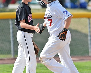 Jeff Lange | The Vindicator  MON, JUL 25, 2016 - Canfield third baseman Connor Daggett (left) congratulates Washington Court House's Jonah Waters after he hit a solo homer in the bottom of the first inning of Monday's game at Fields of Dreams in Boardman.