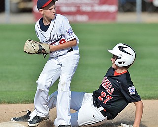 Jeff Lange | The Vindicator  MON, JUL 25, 2016 - Canfield's Broc Lowry (27) slides into second as Washington Court House's Tate Landrum steps on the bag for the out in the top of the third inning of Monday's game in Boardman.