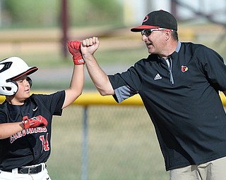 Jeff Lange | The Vindicator  MON, JUL 25, 2016 - Canfield's Ben Slanker (14) is congratulated by first base coach Dan Stricko after hitting a single in the top of the fourth inning of Monday's game against Washington Court House in Boardman.