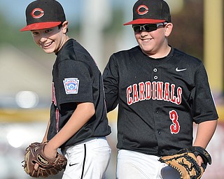 Jeff Lange | The Vindicator  MON, JUL 25, 2016 - Canfield's closer Jameson Beck (left) and first baseman AJ Havrilla share a moment of joy before the start of the bottom of the fourth inning against Washington Court House at Fields of Dreams on Monday.