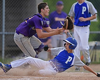 BOARDMAN, OHIO - JULY 26, 2016: Poland's Tyler Berry(3) slides across the plate to score before catcher Dylan Kroggel(12) of Maumee can field the ball on a double steal in the third inning of Tuesday afternoons game at the Fields of Dreams. Poland would go on to win 10-7.  DAVID DERMER | THE VINDICATOR