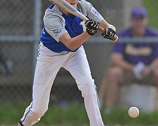 BOARDMAN, OHIO - JULY 26, 2016: Poland's Thomas Fire lays down a sacrifice bunt that would score a run in the third inning of their game Tuesday afternoon at the Fields of Dreams. Poland would go on to win 10-7.  DAVID DERMER | THE VINDICATOR