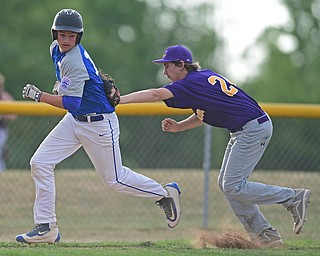 BOARDMAN, OHIO - JULY 26, 2016: Zachary Yaskula(13) of Poland is tagged out by pitcher Zach Freemann(24) of Maumee after being caught in a run down in the third inning of their game Tuesday afternoon at the Fields of Dreams. Poland would go on to win 10-7.  DAVID DERMER | THE VINDICATOR