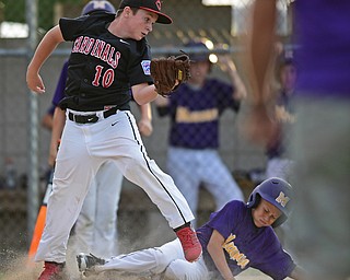 BOARDMAN, OHIO - JULY 26, 2016: Starting pitcher Connor Miller(10) of Canfield looks for the baseball after not fielding the throw while Danny Hazard(8) of Maumee scores on a wild pitch in the second inning of the Ohio 10/11 Little League Championship game Tuesday night at the Fields of Dreams. DAVID DERMER | THE VINDICATOR