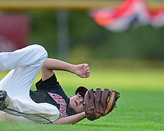 BOARDMAN, OHIO - JULY 26, 2016: Second baseman Luca Ricchiuti(13) of Canfield rolls over on his back after being unable to catch the ball hit by Danny Hazard(8) of Maumee allowing two runs in the second inning of the Ohio 10/11 Little League Championship game Tuesday night at the Fields of Dreams. DAVID DERMER | THE VINDICATOR