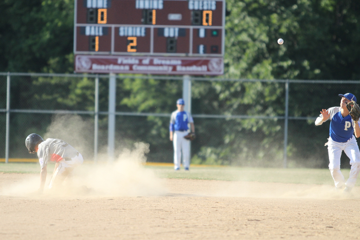 Nikos Frazier | The Vindicator..East Holmes' Brett Miller(3) slides into second as Poland's Stephen Carney(11) attempts to field the ball in the first inning during the Junior Little League State Championship game at the Fields of Dreams in Boardman.