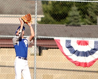 Nikos Frazier | The Vindicator..Poland's Josh Blasko(7) goes for the out in the first inning during the Junior Little League State Championship game at the Fields of Dreams in Boardman.