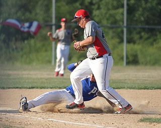 Nikos Frazier | The Vindicator..Poland's Jake Bacon(8) slides into third in the first inning during the Junior Little League State Championship game at the Fields of Dreams in Boardman.