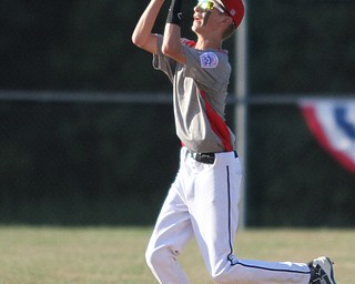 Nikos Frazier | The Vindicator..East Holmes' Patt Miller(17) catches a fly ball in the second inning of the Junior Little League State Championship game at the Fields of Dreams in Boardman.