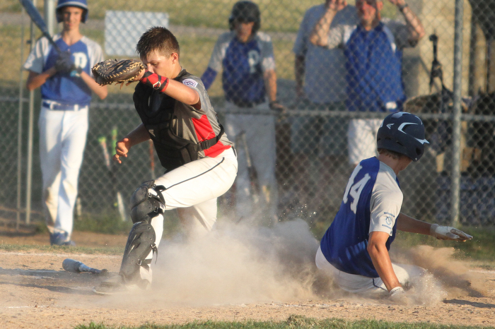 Nikos Frazier | The Vindicator..Poland's Bailey Swogger(14) slides into home in the third inning during the Junior Little League State Championship game at the Fields of Dreams in Boardman.