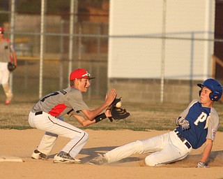 Nikos Frazier | The Vindicator..East Holmes' Patt Miller(17) successfully catches a pass as Poland's Josh Blasko(7) slides into second during the Junior Little League State Championship game at the Fields of Dreams in Boardman.