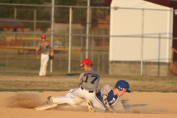 Nikos Frazier | The Vindicator..East Holmes' Patt Miller(17) successfully catches a pass as Poland's Josh Blasko(7) slides into second during the Junior Little League State Championship game at the Fields of Dreams in Boardman.