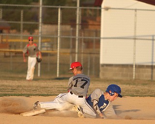 Nikos Frazier | The Vindicator..East Holmes' Patt Miller(17) successfully catches a pass as Poland's Josh Blasko(7) slides into second during the Junior Little League State Championship game at the Fields of Dreams in Boardman.