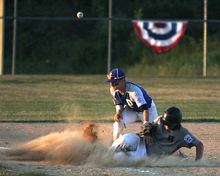 Nikos Frazier | The Vindicator..Poland's Jake Bacon(8) tags an East Holmes' runner as he slides into third with an empty glove in the fifth inning during the Junior Little League State Championship game at the Fields of Dreams in Boardman.